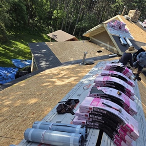 Roof replacement underway with old shingles removed