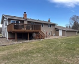 Back exterior of home before vinyl siding renovation near Hudson, WI