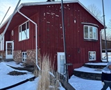 Red exterior siding before vinyl siding replacement project