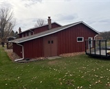 Existing red siding before home exterior renovation near Hudson, WI